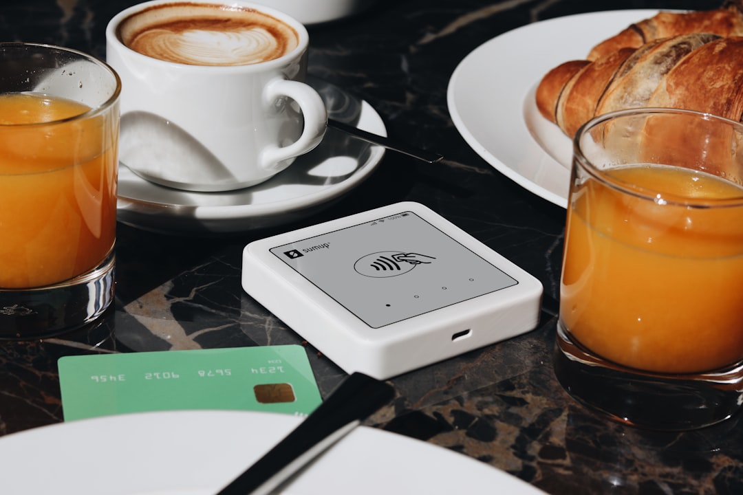 A SumUp card reader is placed on a table, ready to accept contactless payments. The setup is ideal for small businesses and cafés, offering a sleek and efficient way for entrepreneurs to accept payments.